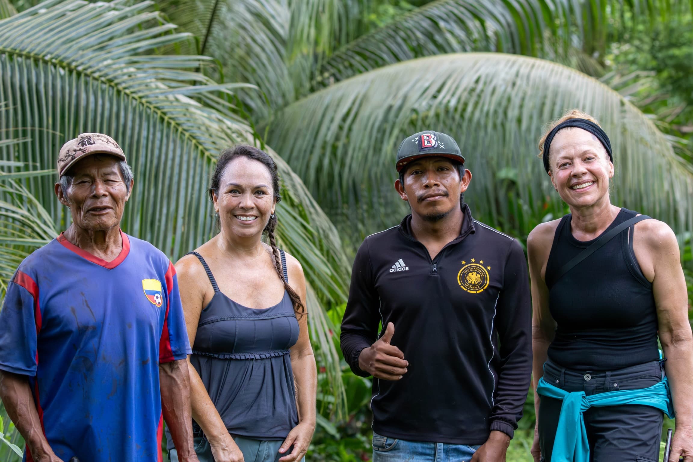 Multicultural community partnership at Dolphin Blue Paradise, Bocas del Toro - diverse team of staff, Ngäbe-Buglé community members, and guests working together for sustainable tourism and conservation