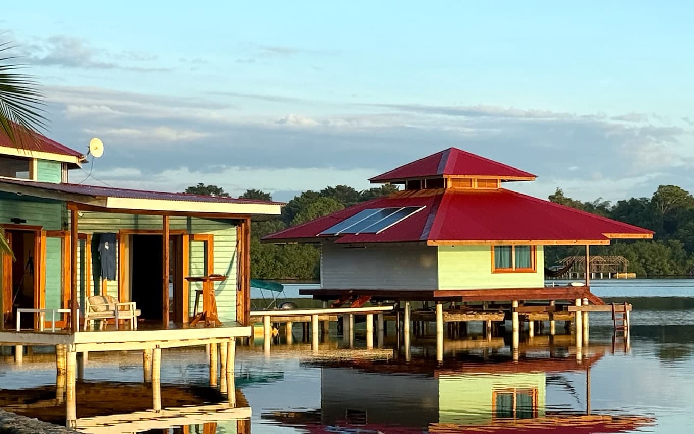 Overwater cabanas reflected in Dolphin Bay